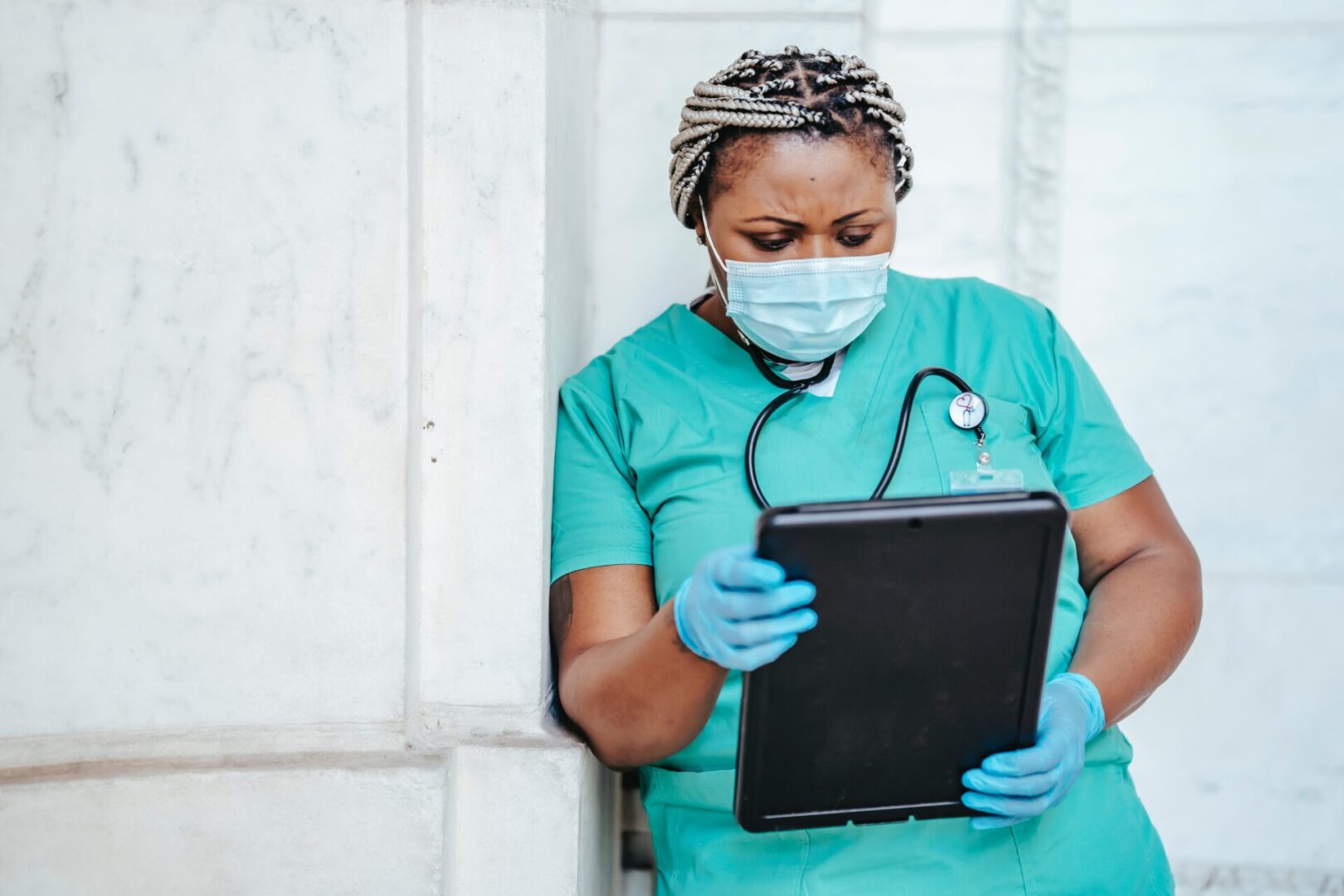 Crop nurse in mask and gloves with papers